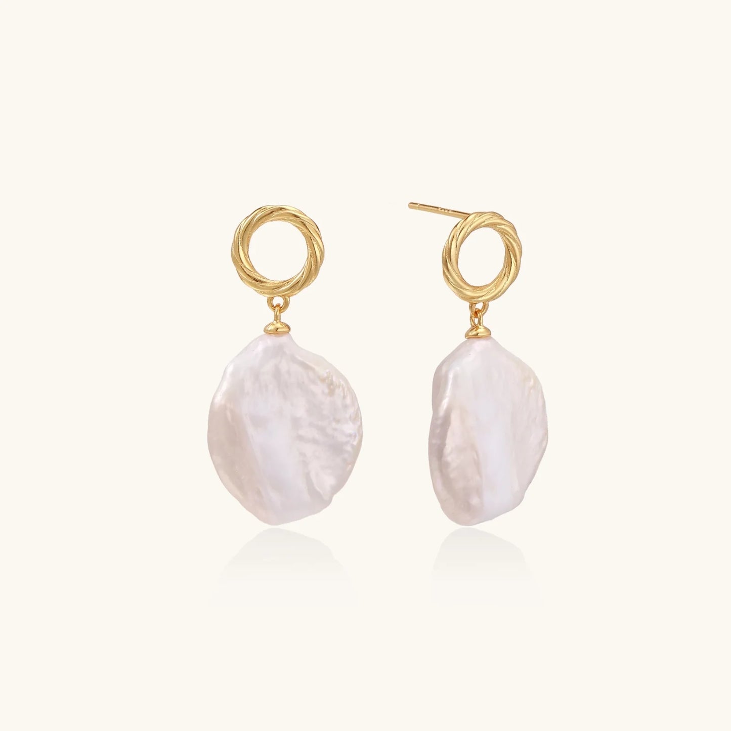 18K gold vermeil twisted circle studs with organic white baroque pearl drops on cream background