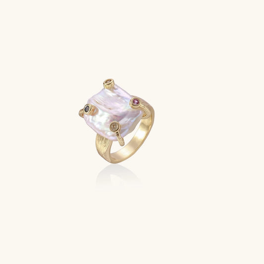 Gold ring with large iridescent baroque pearl and four colored gemstones on textured band