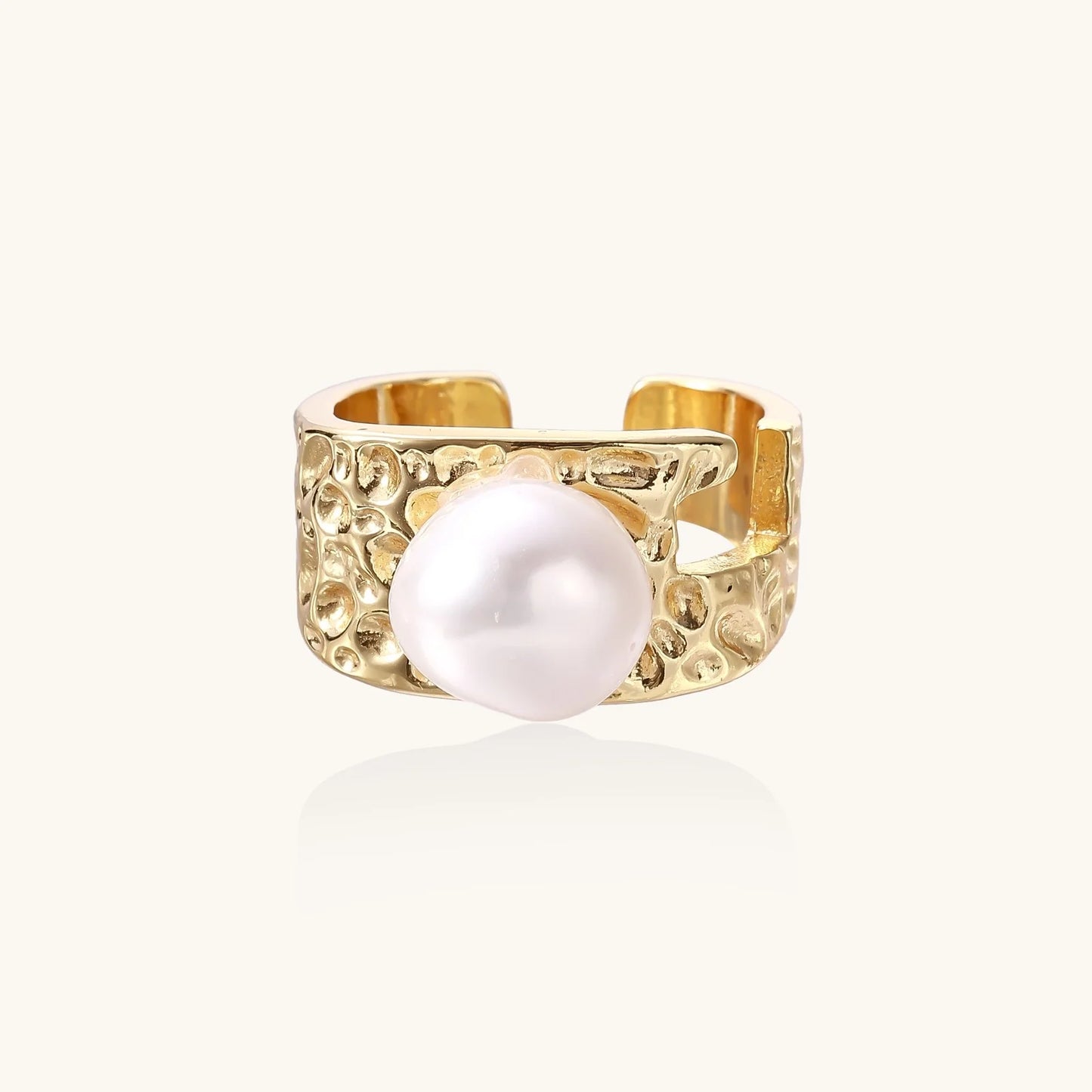 Wide gold-plated ring with organic textured band and white freshwater pearl centerpiece