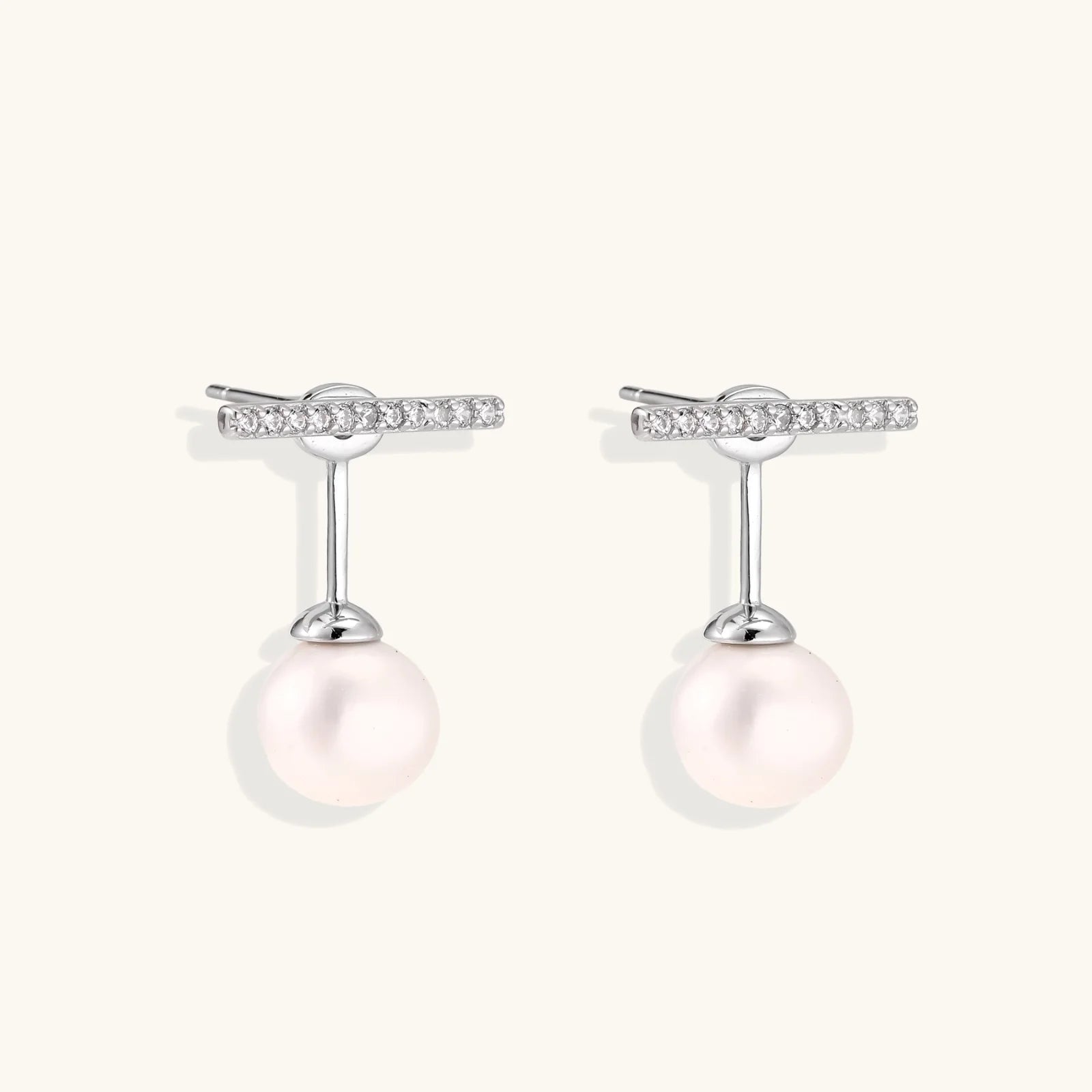 Rhodium-plated sterling silver ear jacket earrings with diamond-set horizontal bar and freshwater pearl drop