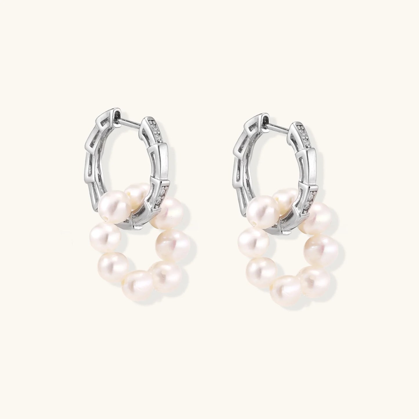 Rhodium-plated silver hoop earrings with freshwater pearls arranged in crescent formation and diamond accents