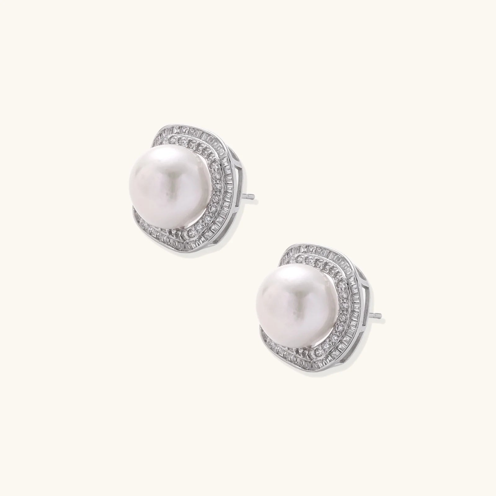 Cushion-shaped sterling silver stud earrings with freshwater pearls surrounded by geometric diamond halos