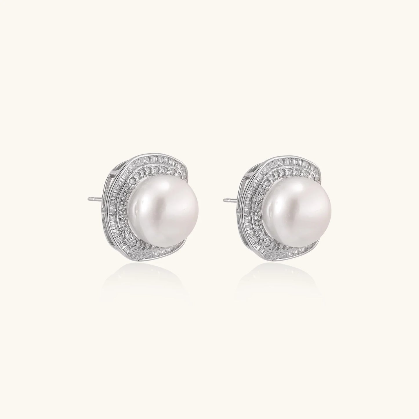 Cushion-shaped sterling silver stud earrings with freshwater pearls surrounded by geometric diamond halos