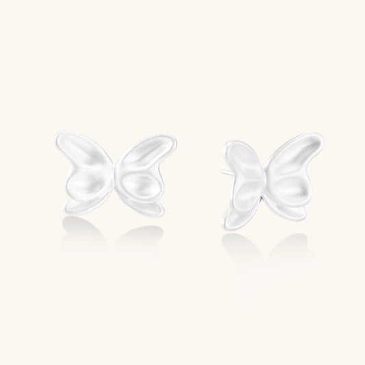 Pair of translucent butterfly-shaped stud earrings with frosted finish and dimensional wing details on white background