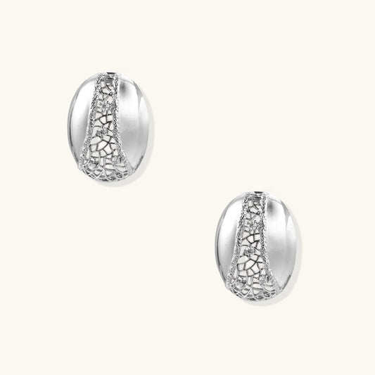White gold-plated dome hoop earrings with geometric lattice pattern and zirconia stones on cream background