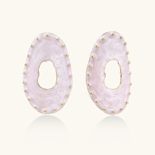 Oval lavender enamel earrings with marbled finish and gold-plated beaded border on cream background.