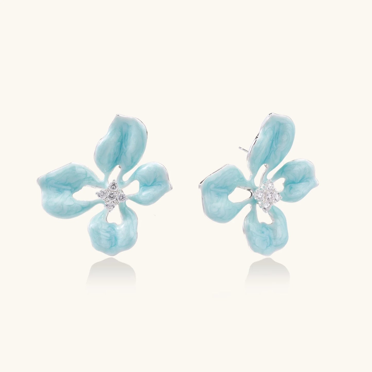 Turquoise enamel flower stud earrings with marbled finish and crystal centers on 18K gold plated brass