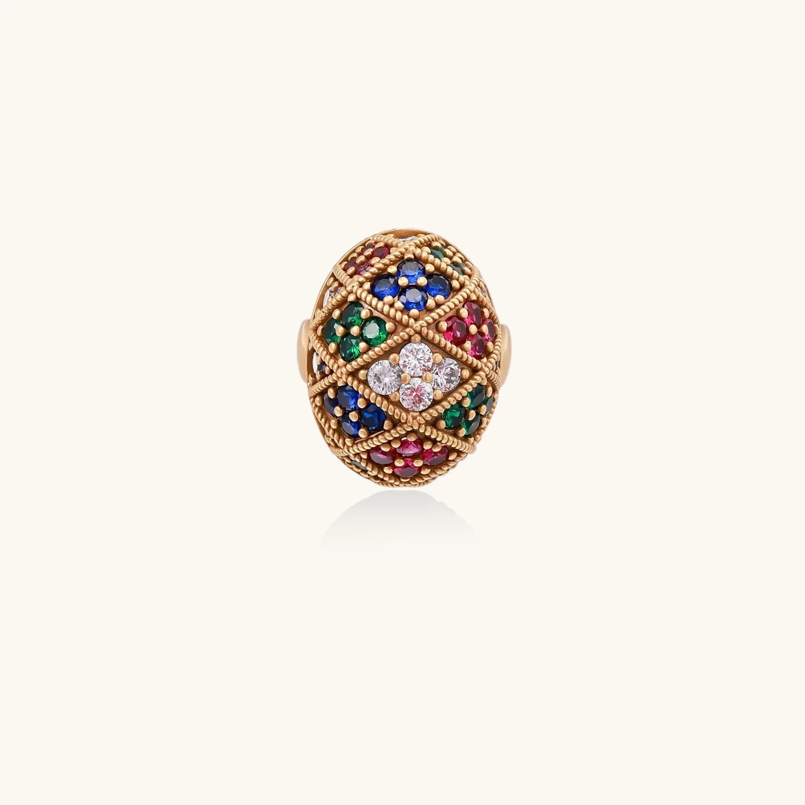 Oversized gold ring with geometric mosaic pattern featuring multicolor zirconia stones in ruby, emerald, sapphire, and clear tones.