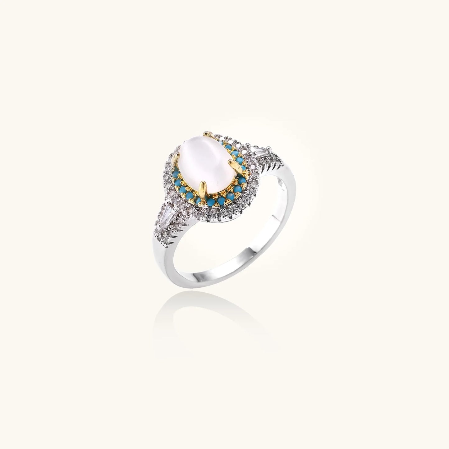 Vintage-style cocktail ring with luminous cat's eye center stone surrounded by turquoise and crystal double halo on white gold plated band