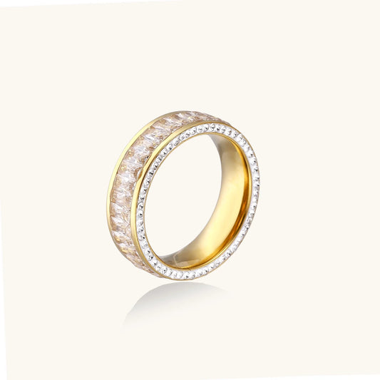 14K gold-plated ring with dual rows of clear baguette and round zirconia stones on cream background.