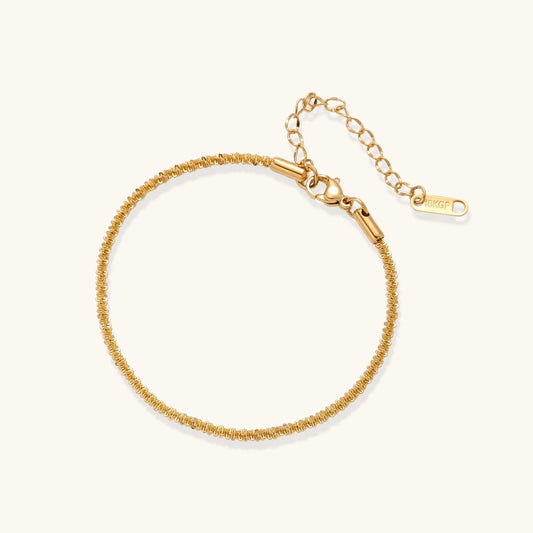 Delicate 18K gold-plated stainless steel bracelet with textured beaded chain on cream background