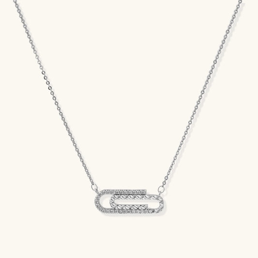 White gold plated necklace with dual-frame geometric pendant featuring crystal pavé border on pale background.