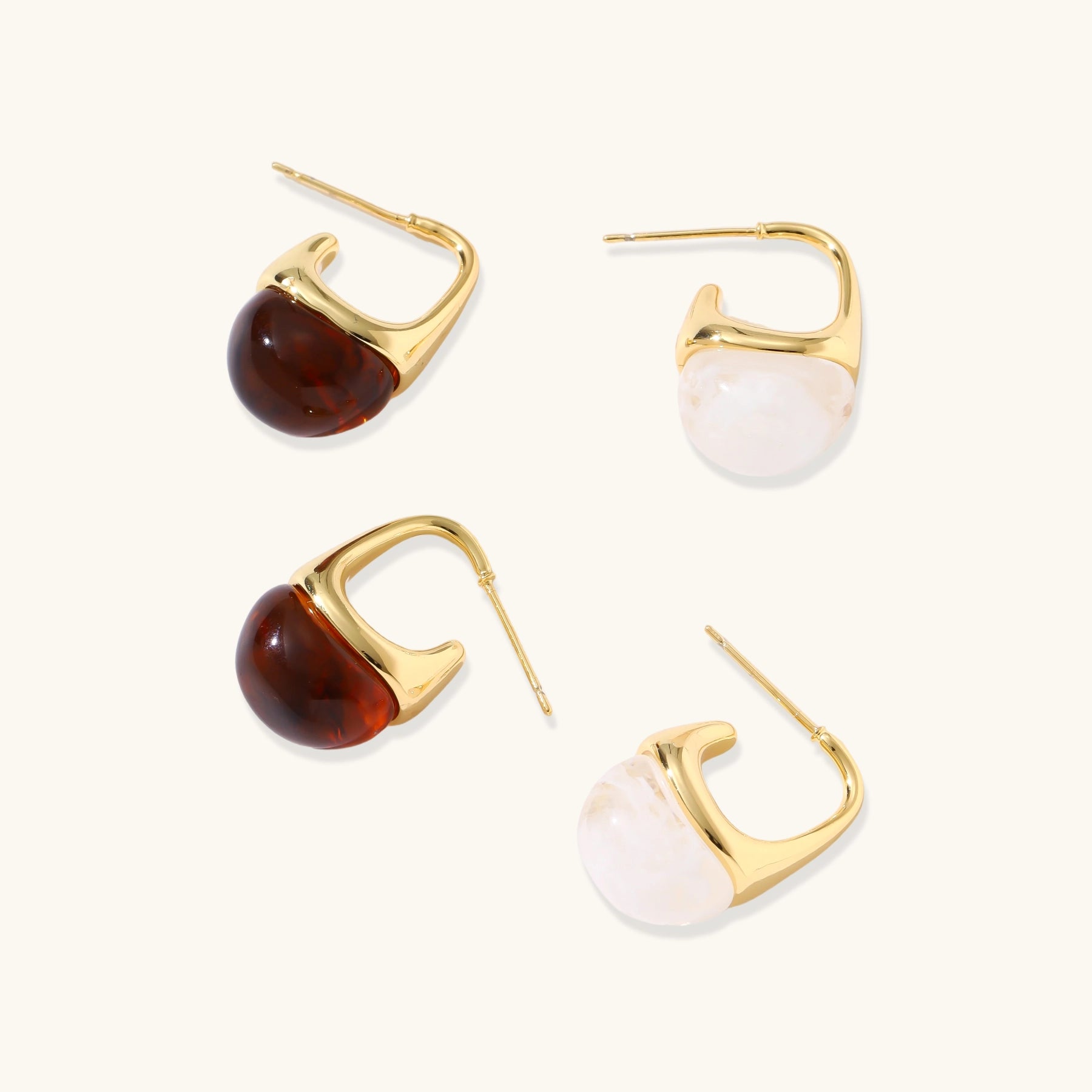 Modern drop earrings with curved gold-plated copper tops and amber resin bottoms creating an organic teardrop silhouette.