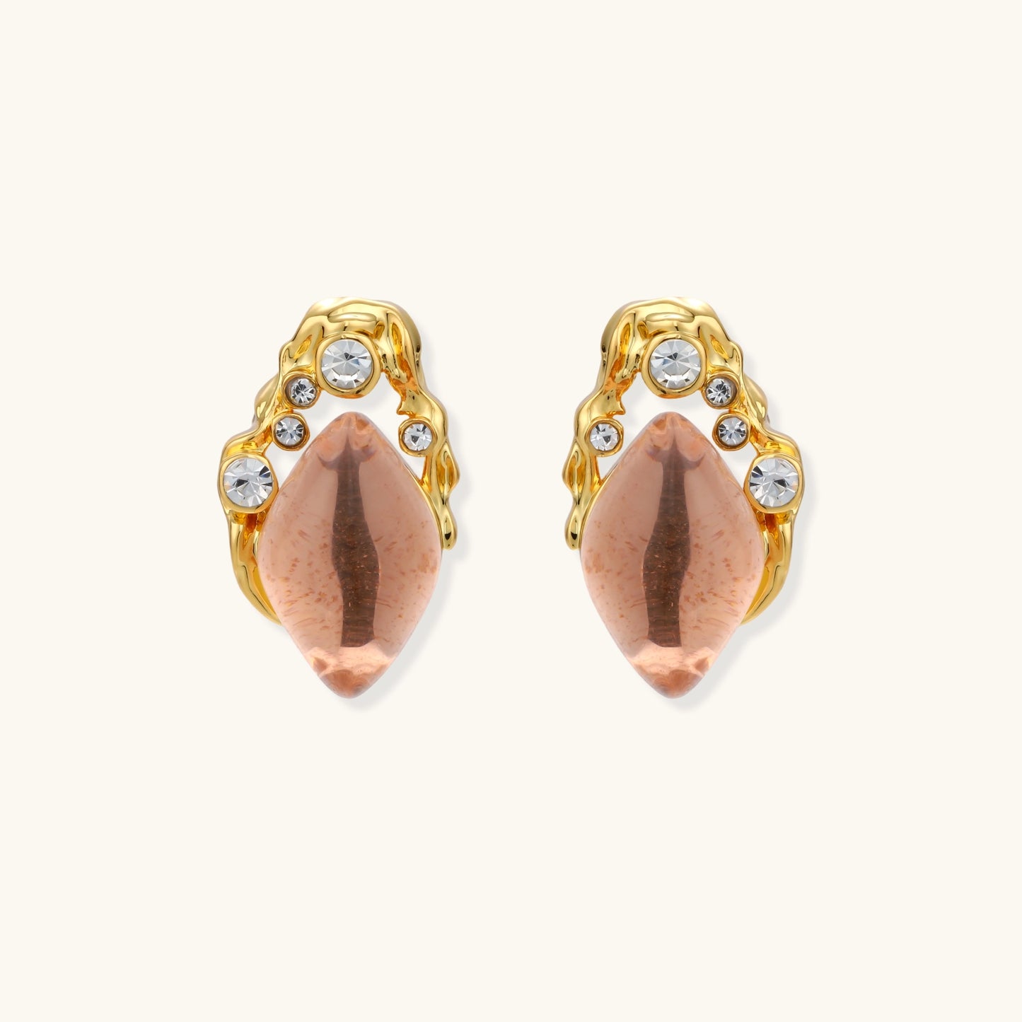 Gold-plated baroque stud earrings with coral-pink liuli stones and cubic zirconia crystals on white background.